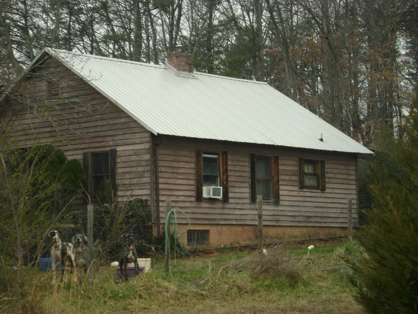 White metal roof on an old wood sided farmhouse, from a Metal Roof Installation job in Walworth